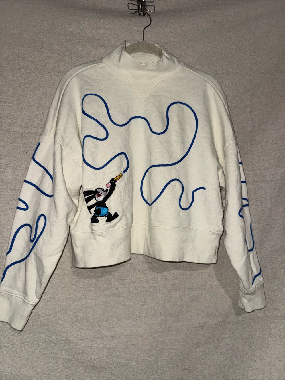 Disney Oswald Cream Sweatshirt with Black Logo Tag